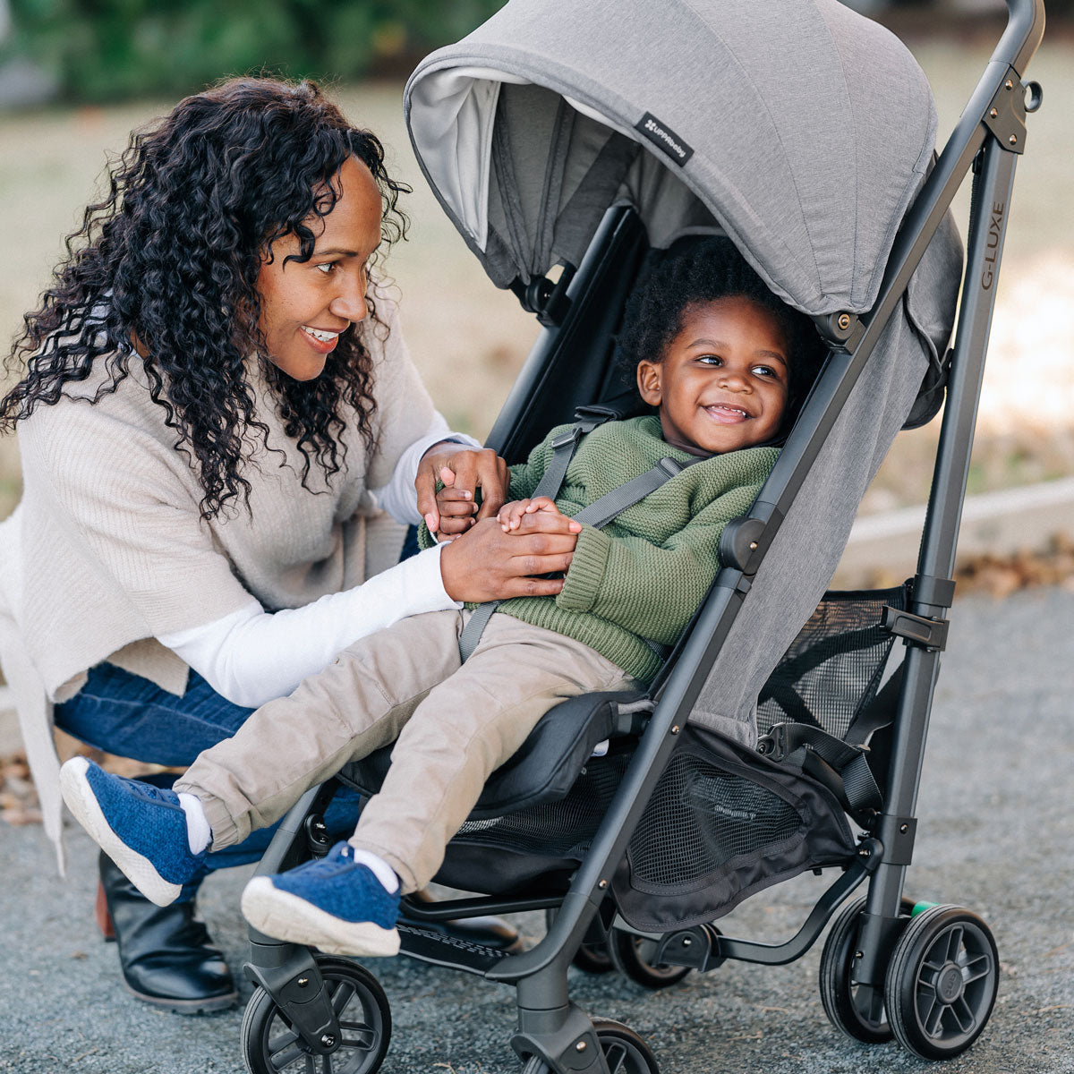 Woman looks at child in UPPAbaby G-LUXE Stroller - Greyson