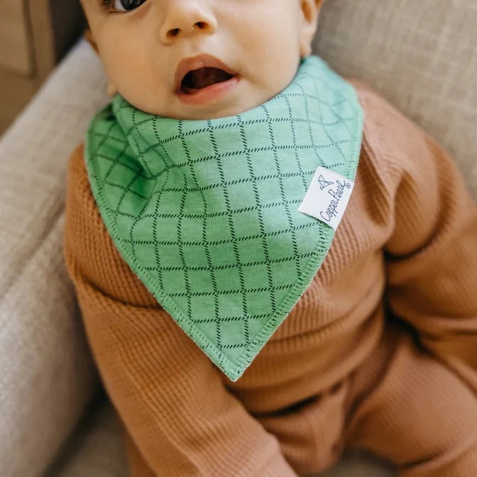 Baby wearing Copper Pearl Single Holiday Bandana Bib - Griswold Green Grid
