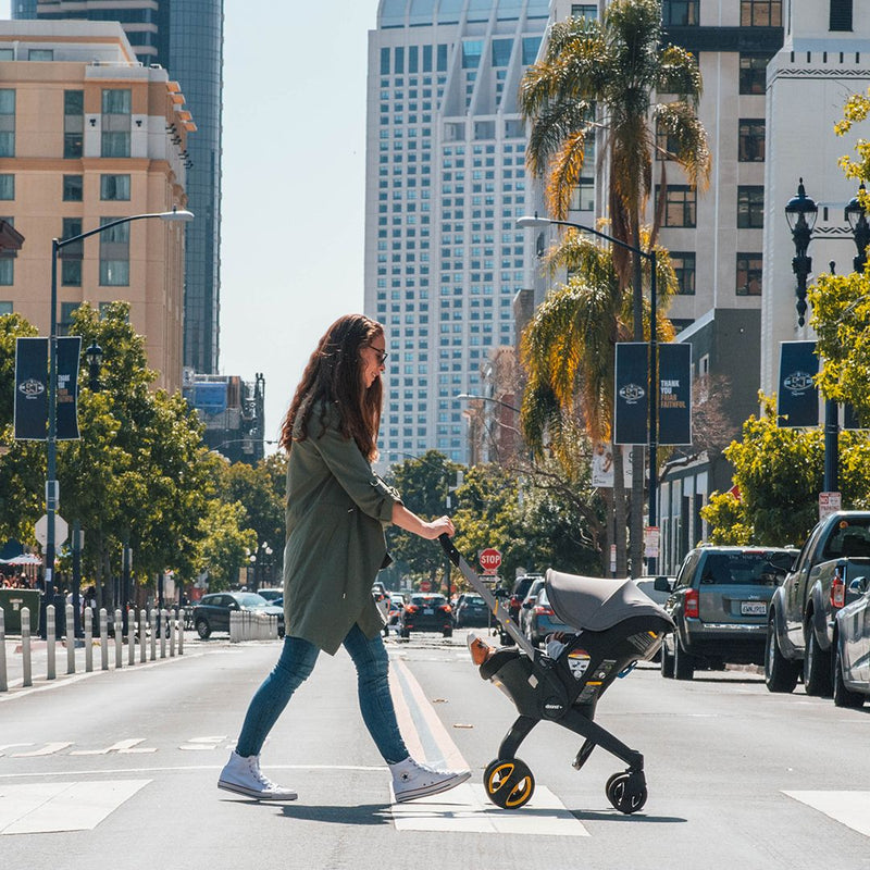 walking baby in car seat stroller Doona Infant Car Seat and Stroller