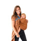 Woman carrying Child in Kyte BABY Ring Sling - Cedar with Rose Gold Rings