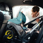 Dad puts baby in car in Doona Infant Car Seat and Stroller