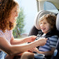 Mom buckles child into Maxi-Cosi Pria All-in-One Convertible Car Seat