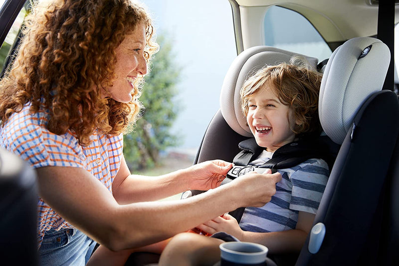 Mom buckles child into Maxi-Cosi Pria All-in-One Convertible Car Seat