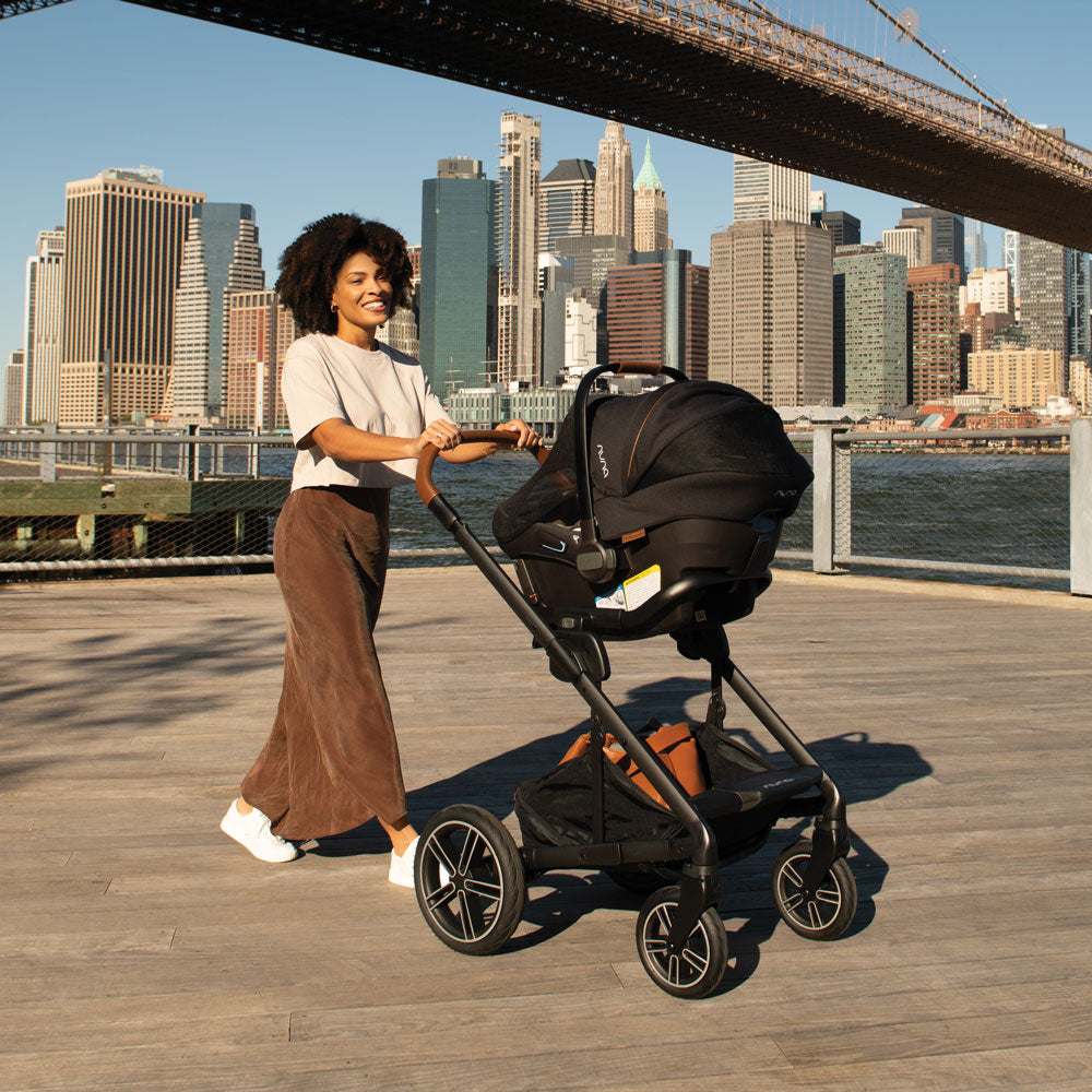 Woman uses Nuna MIXX Next Stroller and PIPA Urbn Car Seat Travel System