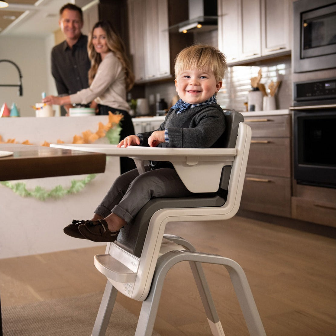 Toddler sitting in Nuna ZAAZ High Chair with MagneTech Secure Snap