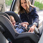 Woman buckles child in Nuna RAVA Convertible Car Seat