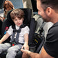 Man helps child out of Nuna REVV Rotating Convertible Car Seat