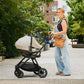 woman pushes Nuna TRIV Next Stroller with car seat attached