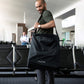 Man carries Nuna TRVL Stroller in storage bag