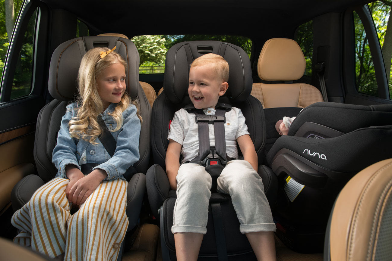 Children ride in Nuna EXEC Convertible Car Seats in different modes
