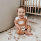Baby boy wears Lovedbaby Slub Jersey Crewneck Bodysuit - Adobe Stripe