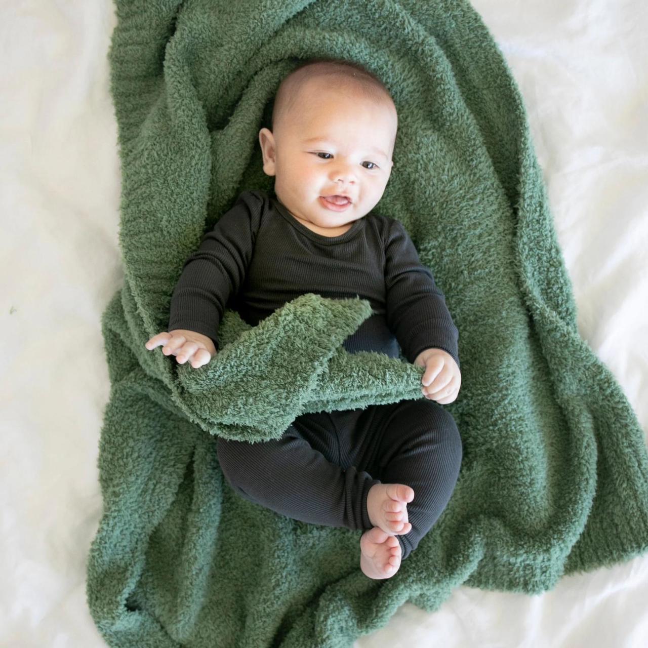 Baby laying on Saranoni Receiving Bamboni Blanket - Olive