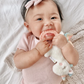 Baby chewing on Itzy Ritzy Ritzy Rattle Pal - Plush Rattle Pal with Teether - Unicorn