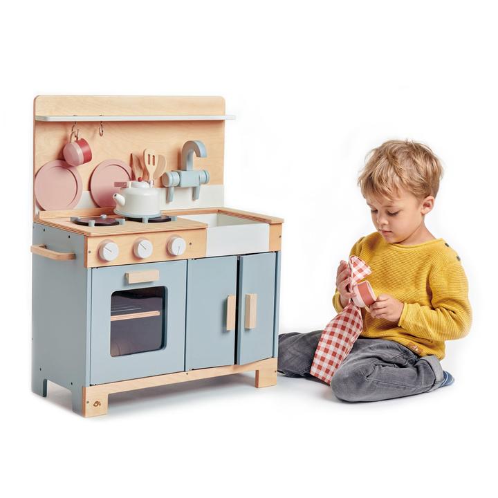 Little boy plays with Tender Leaf Toys Mini Chef Home Kitchen