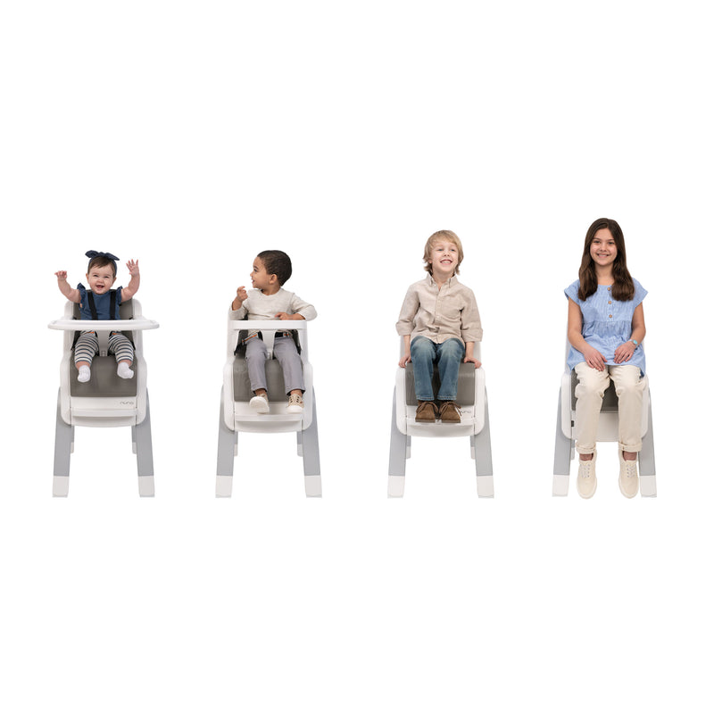 Children sitting in Nuna ZAAZ High Chair with MagneTech Secure Snap - Frost