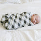 Sleeping Baby Swaddled in Saranoni Bamboo Muslin Swaddle Blanket - Buffalo Plaid