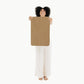 Woman holds up Gathre Micro Mat - Camel