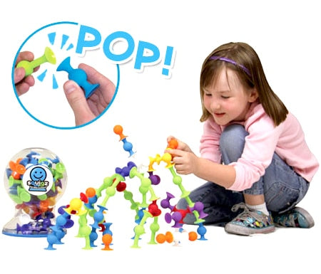 Child Playing with Fat Brain Toys Squigz Starter Set
