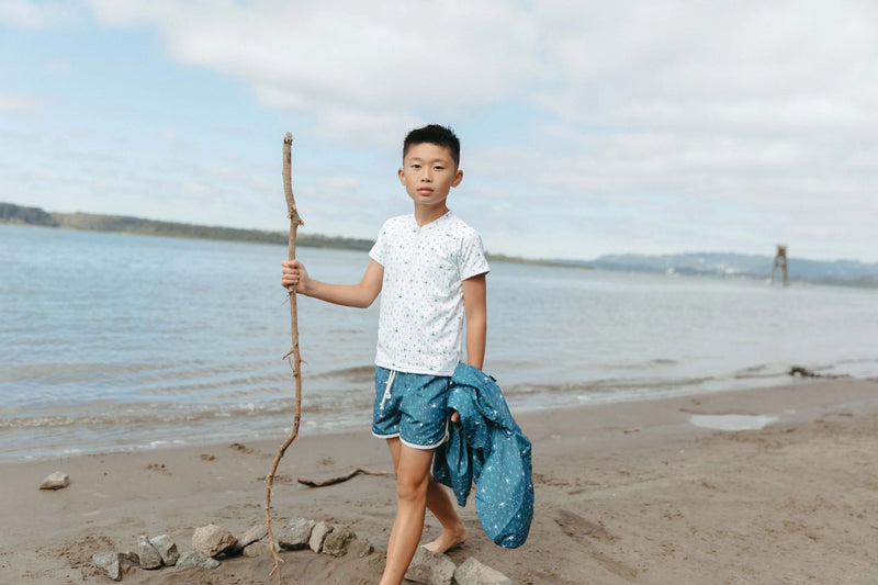 Boy on beach wearing Fin and Vince Board Shorts - Paisley Trail