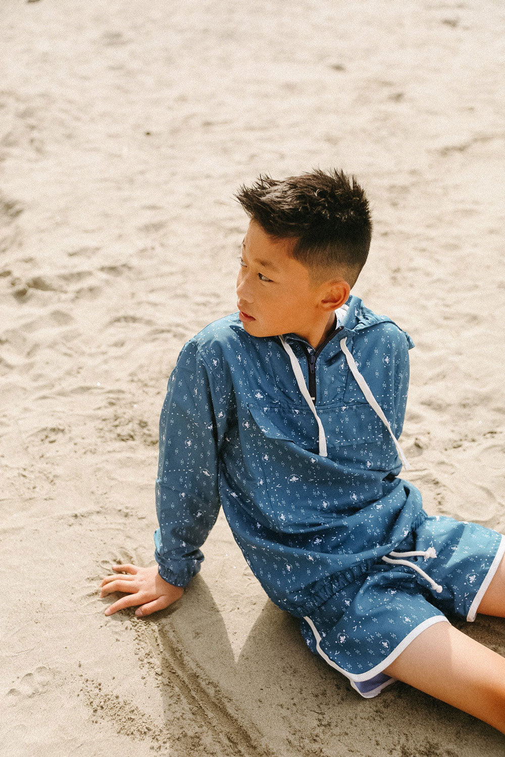 Boy on beach wearing Fin and Vince Board Shorts - Paisley Trail
