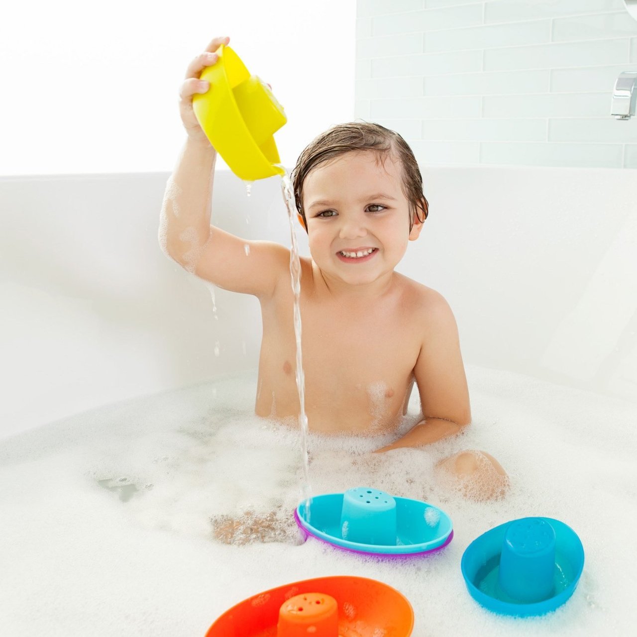 Child in Bath Playing with Boon FLEET Stacking Boats - Navy / Multi