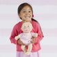 Girl holding Manhattan Toy Company Baby Stella - Peach Doll