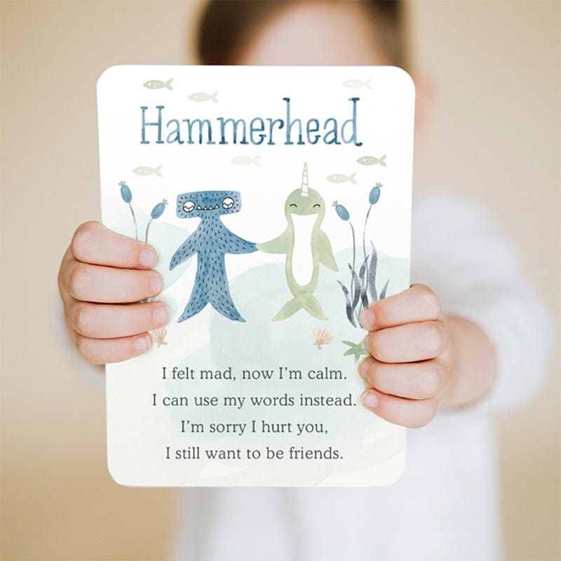 Child holding up affirmation card from Slumberkins Hammerhead Snuggler - Pacific / Blue