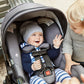 Baby smiling at toddler while riding in Nuna PIPA attached to Nuna PIPA Adapter for UPPAbaby VISTA and CRUZ Strollers