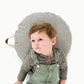 Little boy lays on Gathre Mini Circle Floor Cushion - Stone Stripe