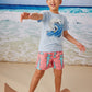Little boy wears Tea Collection Shortie Swim Trunks - Hammerhead Sharks