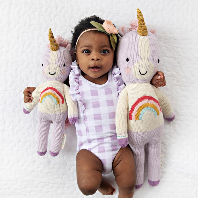 Baby with arms around Cuddle and Kind Zoe the Unicorn